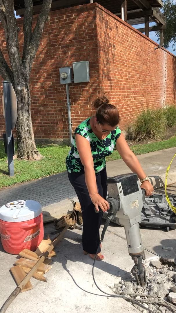 Breaking up an old concrete slab outside a commercial building
