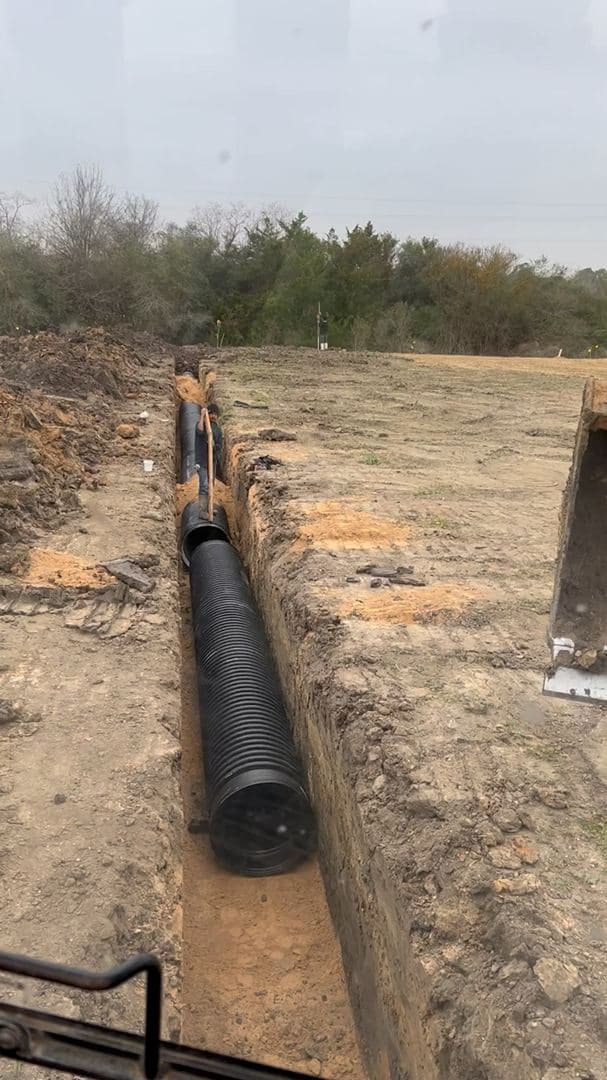 Drainage pipe laid in a trench ahead of backfilling