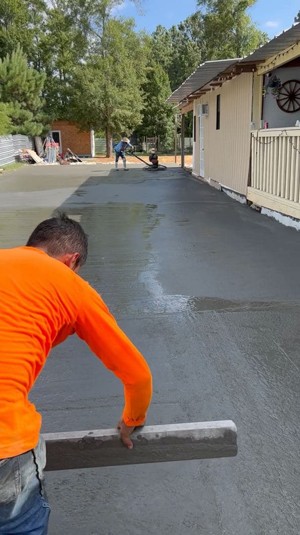 Power-troweling a large residential driveway to a smooth finish