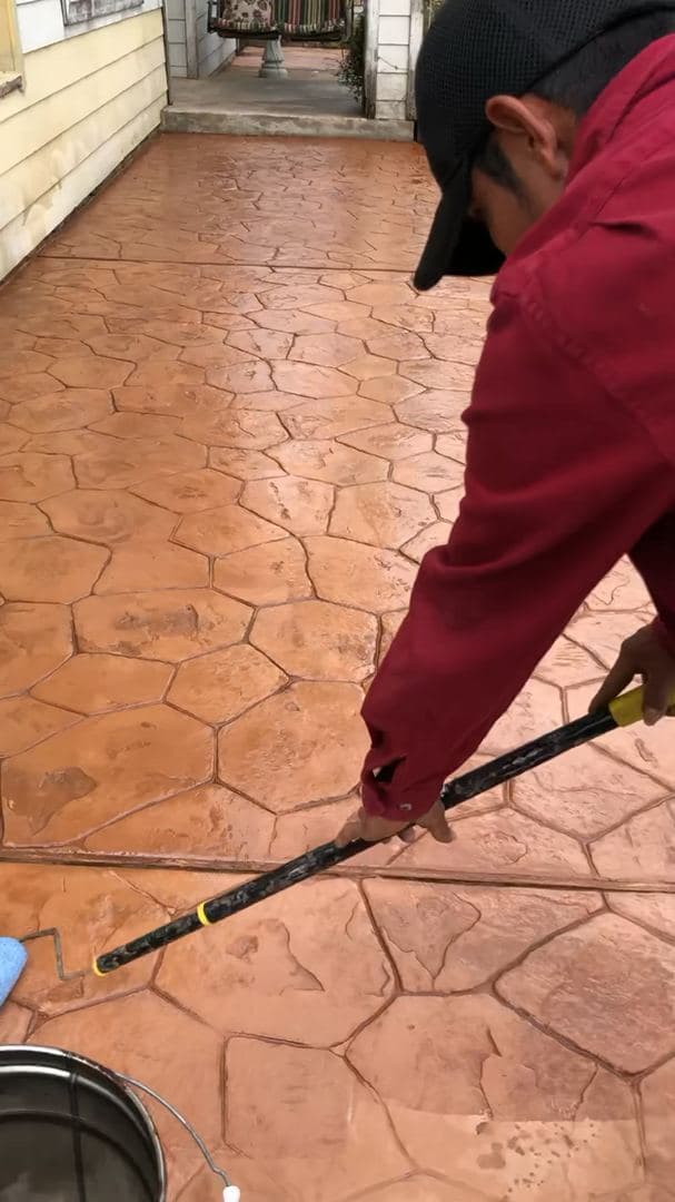 Hand-stamping a decorative concrete patio pattern