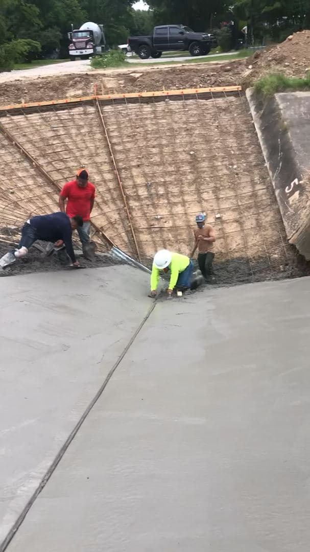 Iron Wolf Concrete crew finishing a residential driveway pour together