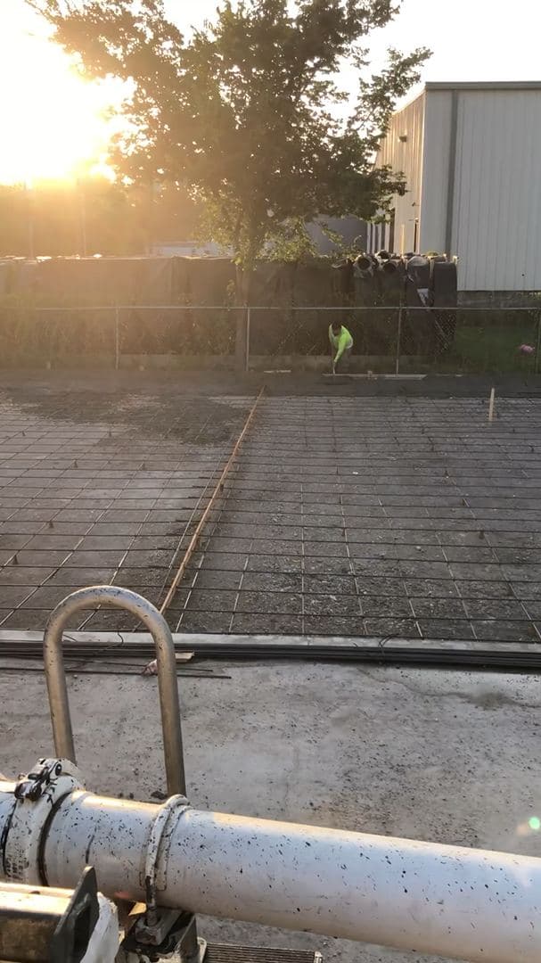 Concrete truck chute discharging concrete on a job site