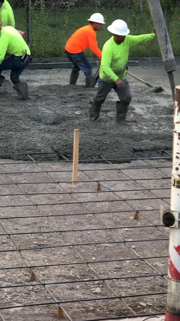 Close-up of a concrete truck's discharge mechanism during a pour
