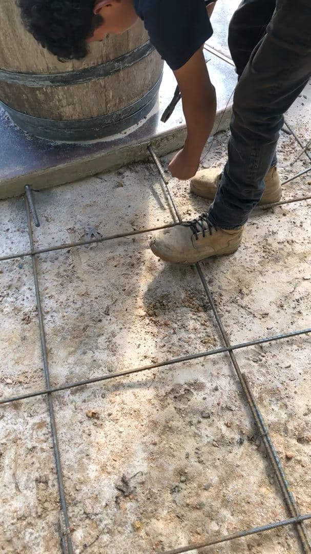 Hand-finishing joints on a concrete walkway