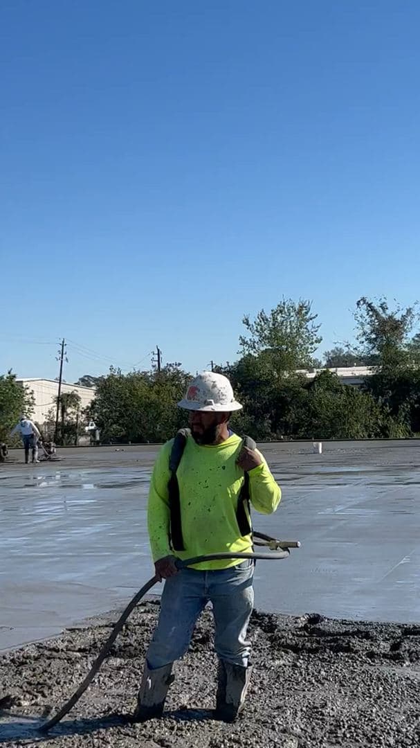 Iron Wolf Concrete crew member on a freshly finished commercial slab