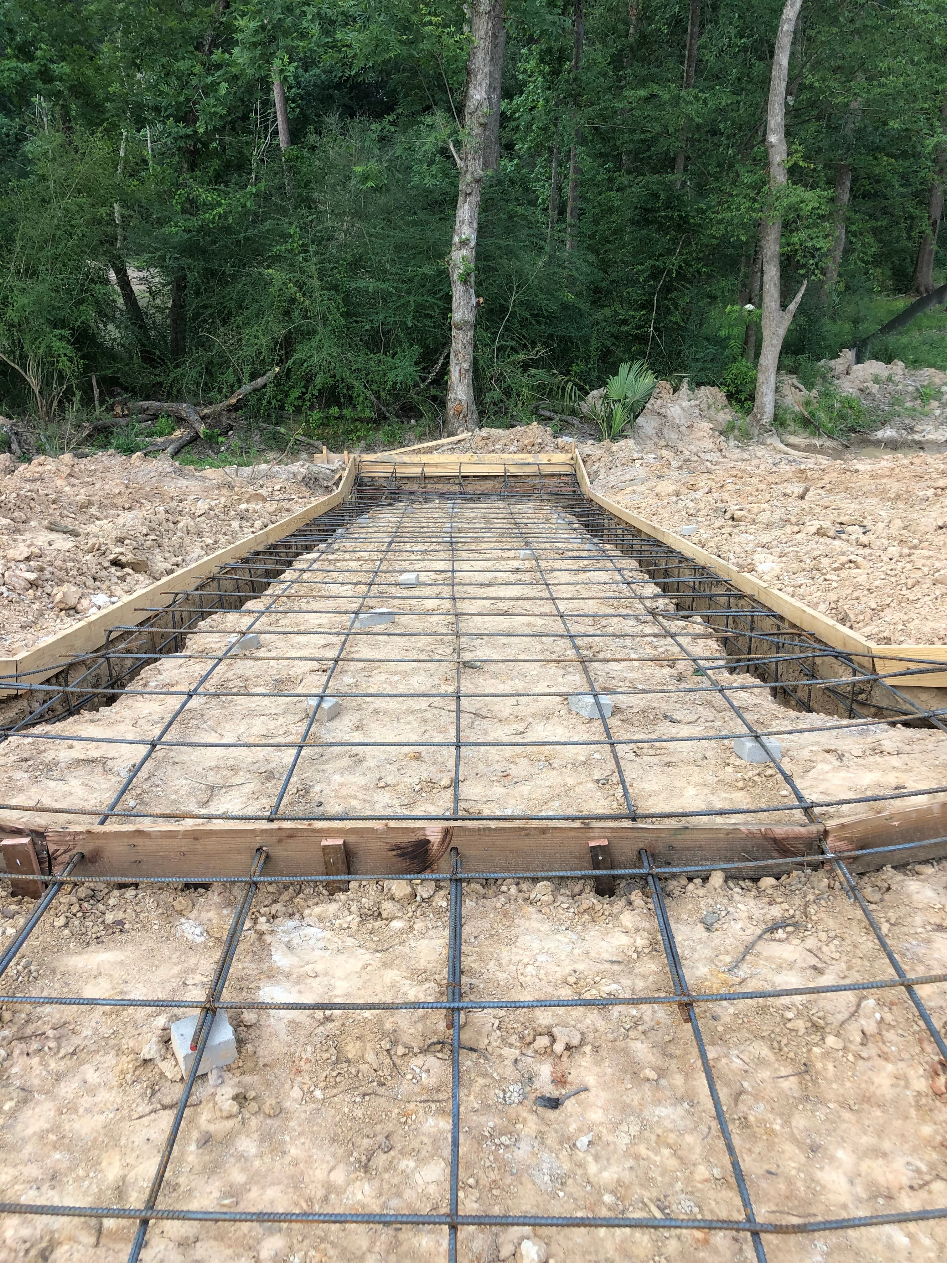 Iron Wolf Concrete crew preparing a rebar foundation grid before a pour