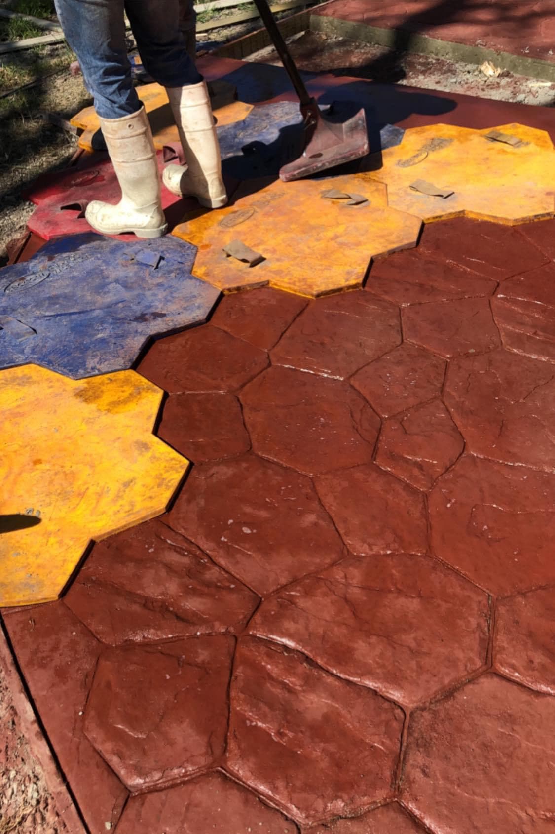 Colorful stamped concrete patio finished by Iron Wolf Concrete
