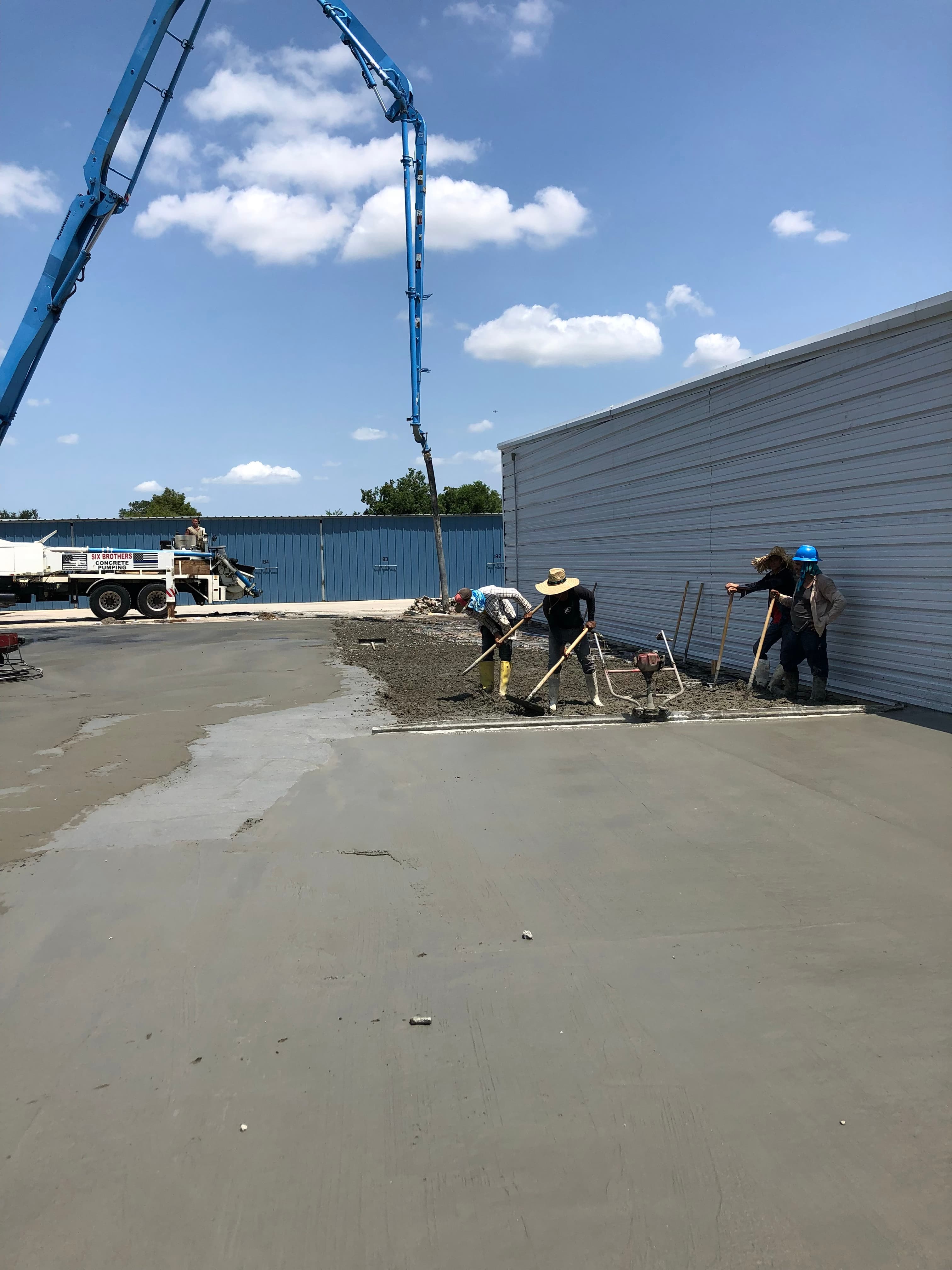 Iron Wolf Concrete crew guiding a concrete pump hose during a pour