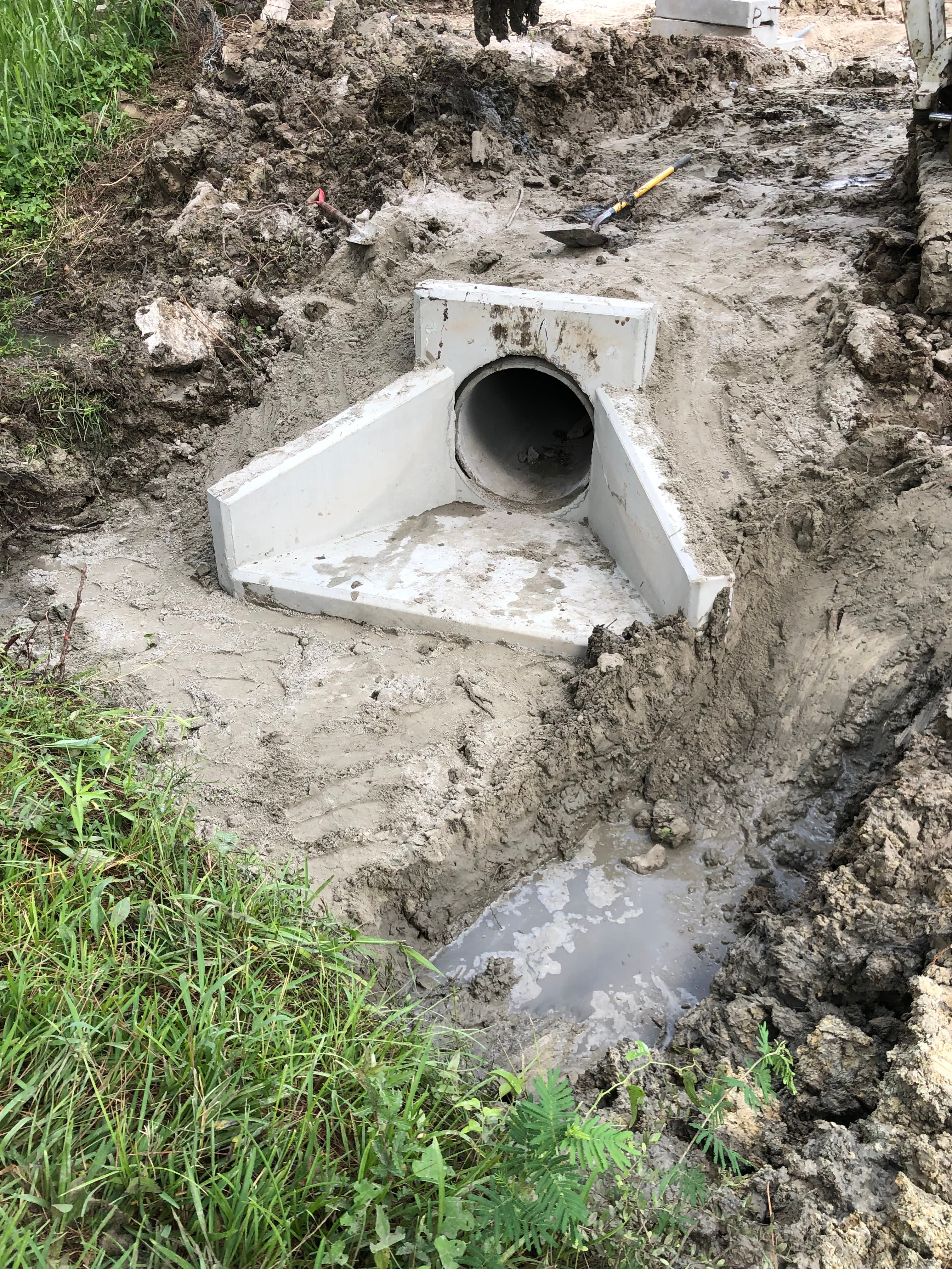 Concrete sitework and drainage preparation on a Houston-area job site