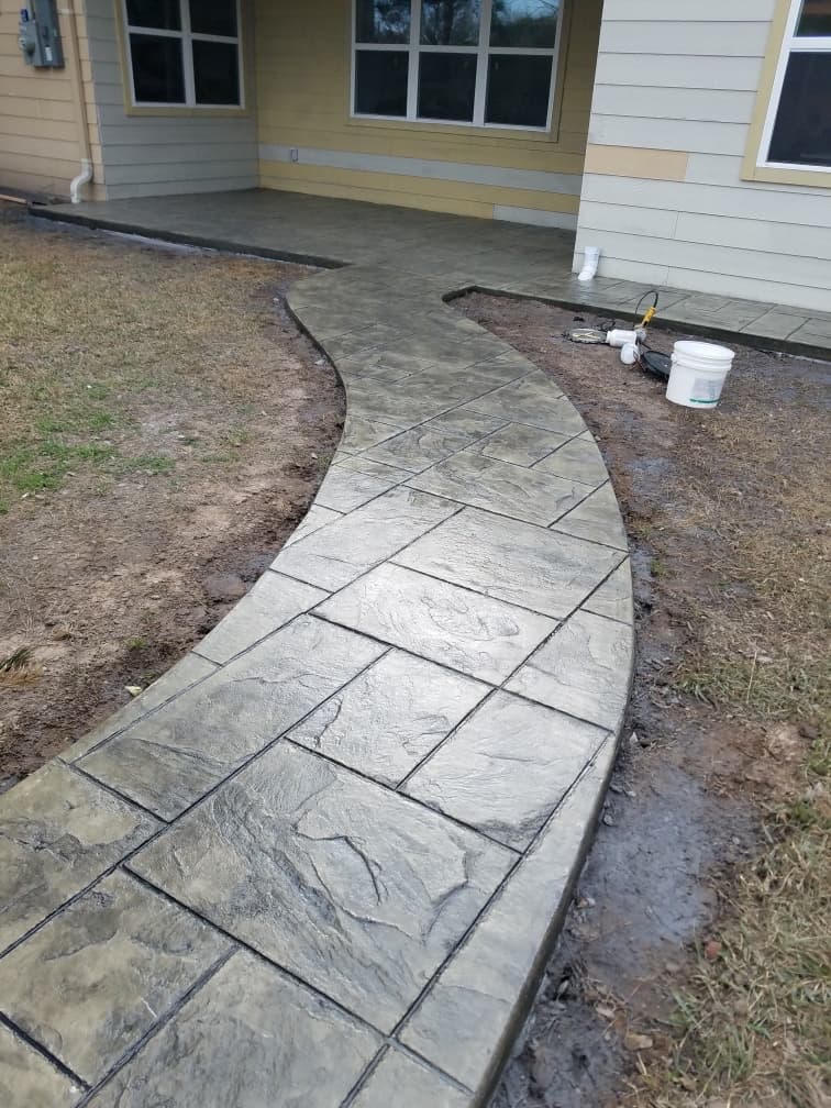 Stamped concrete walkway leading to a home entrance